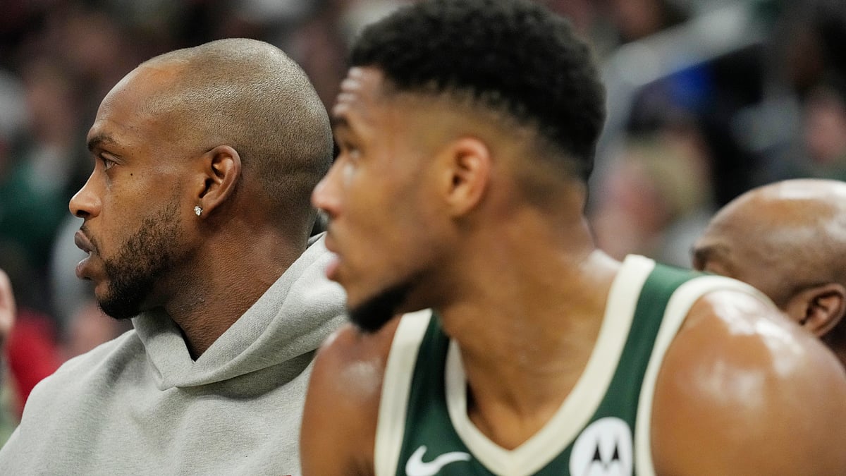 Khris Middleton (L) has not played this season