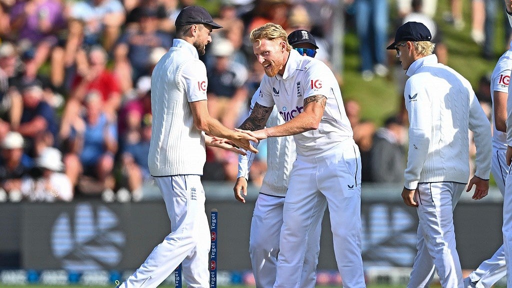 AP/Kerry Marshall                   : Ben Stokes is congratulated by teammate Joe Root, left, after taking the wicket of New Zealand's Tom Latham during during day one of the 2nd Test between New Zealand and England at the Basin Reserve in Wellington.