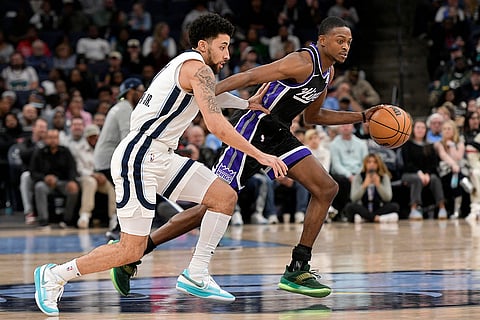 NBA 2024-25: Kings guard De'Aaron Fox handles the ball against Grizzlies guard Scotty Pippen Jr.