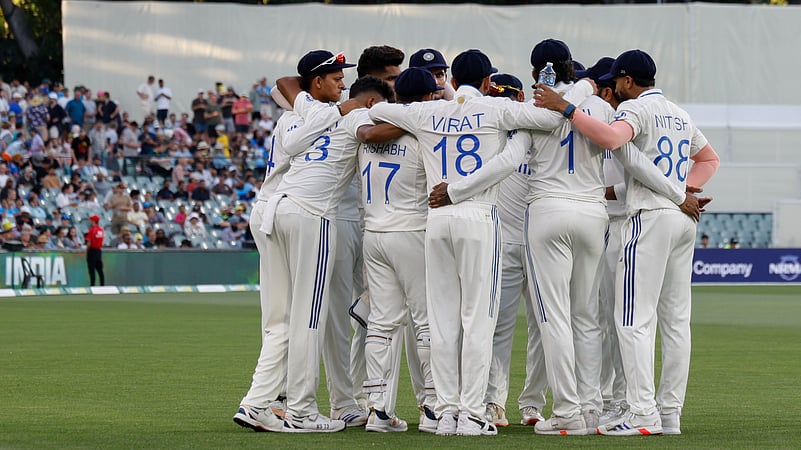 Indian players huddle before the start of Australias innings on day 1. AP Photo