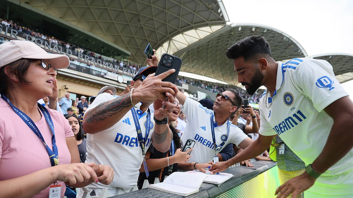 India's Mohammed Siraj signs autographs for fans after the second cricket test match between Australia and India at the Adelaide Oval. - AP Photo/James Elsby