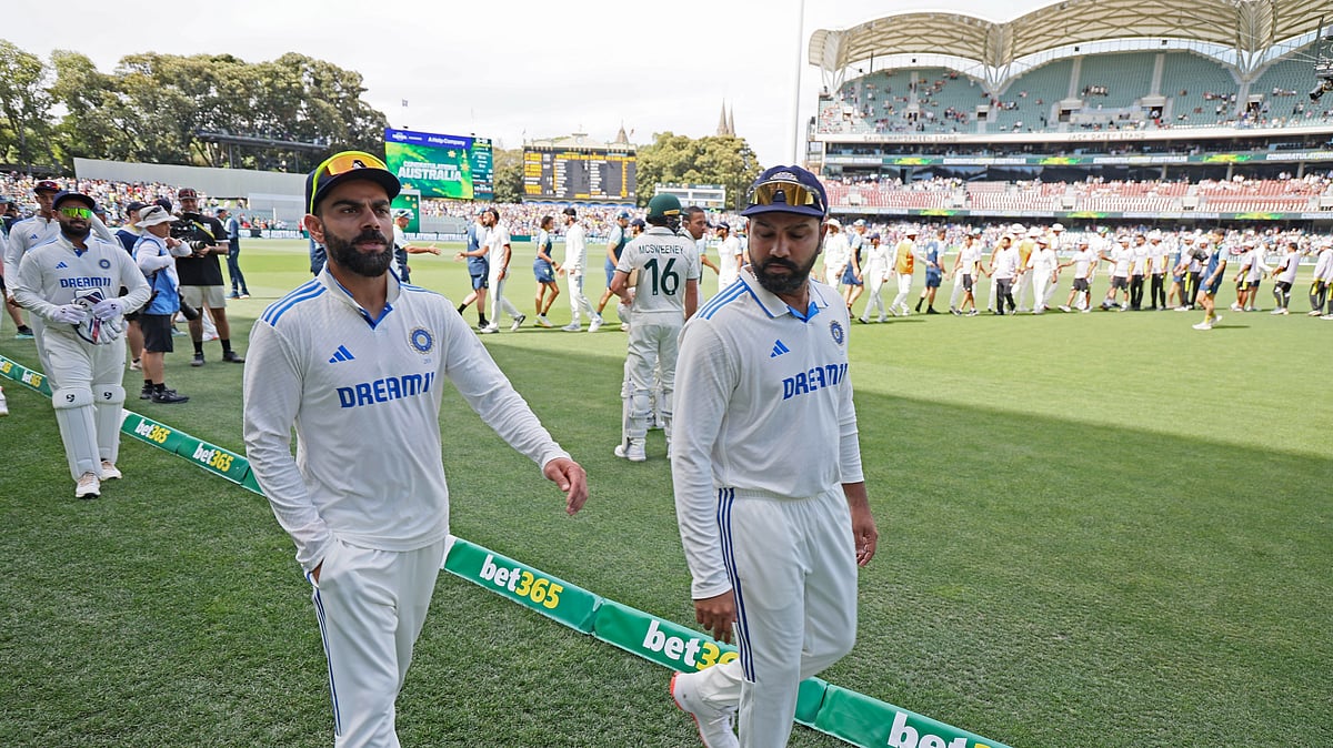 India's captain Rohit Sharma, right, and teammate Virat Kohli leave the field after their loss in the second cricket test match against Australia at the Adelaide Oval. - AP Photo/James Elsby