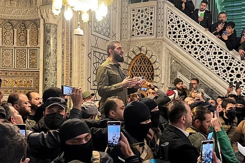 Hayat Tahrir al-Sham leader Abu Mohammed al-Julani speaks to a crowd at Ummayad Mosque in Damascus, after Syrian rebels announced that they had ousted President Bashar al-Assad, on December 8, 2024 [Mahmoud Hassano/Reuters]