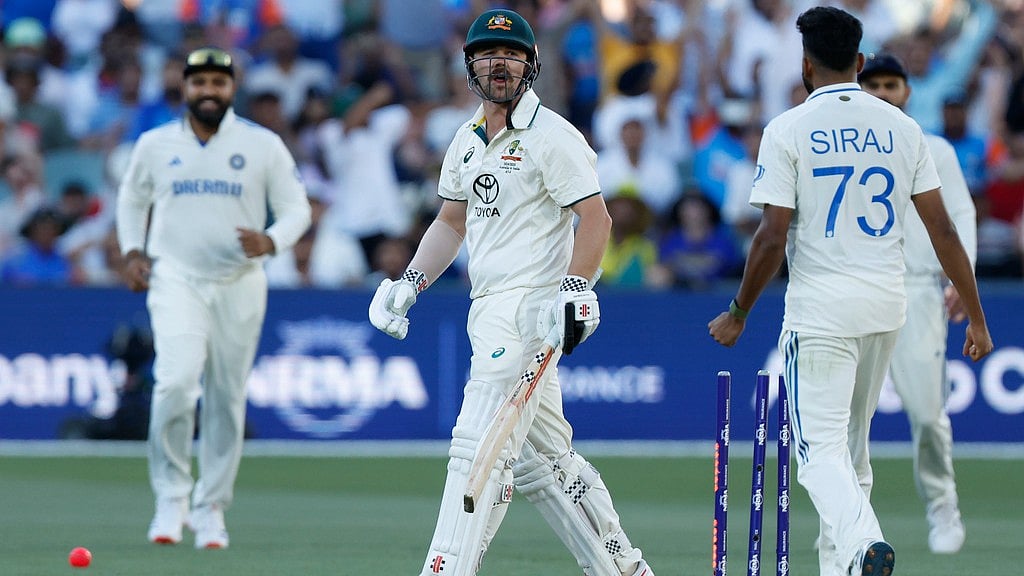 AP/James Elsby : Mohammed Siraj (right) gives Travis Head a send-off after dismissing him during the second day of the second Test between India and Australia in Adelaide.