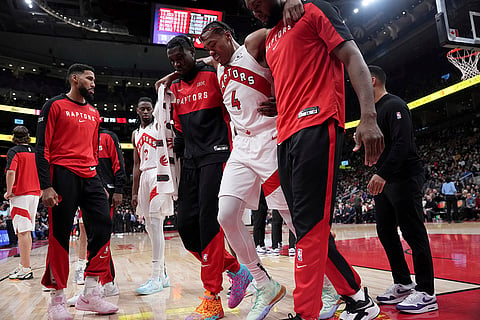 NBA Basketball: Raptors forward Scottie Barnes (4) is helped off the court after suffering an injury