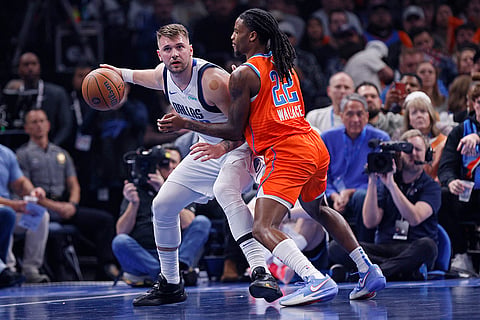 NBA Cup quarterfinals: Mavericks guard Luka Doncic, left, handles the ball as Thunder guard Cason Wallace (22) defends