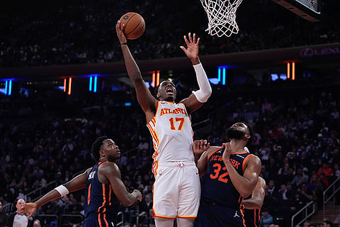 NBA Cup Quarter-Final: Hawks' Onyeka Okongwu shoots over New York Knicks' Karl-Anthony Towns and OG Anunoby 