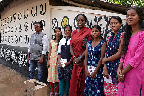 Mithu Sen with the collaborators of Pearson Pally infront of her installation work on Ol chicki script 