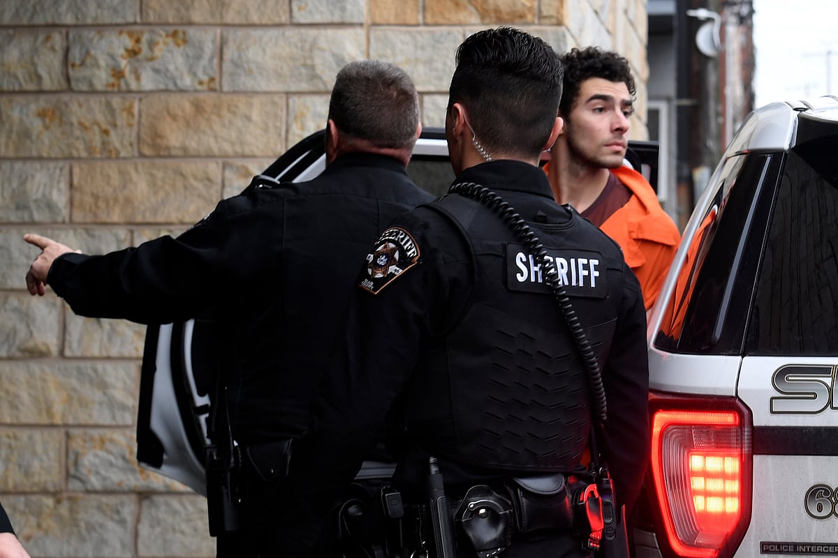 AP Photo/Gary M. Baranec : Murder suspect of UnitedHealthcare CEO, Luigi Nicholas Mangione is escorted into Blair County Courthouse, Tuesday, Dec. 10, 2024, in Hollidaysburg, Pa.
