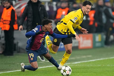 UEFA Champions League: Barcelona's Lamine Yamal fights for the ball against Dortmund's Ramy Bensebaini 