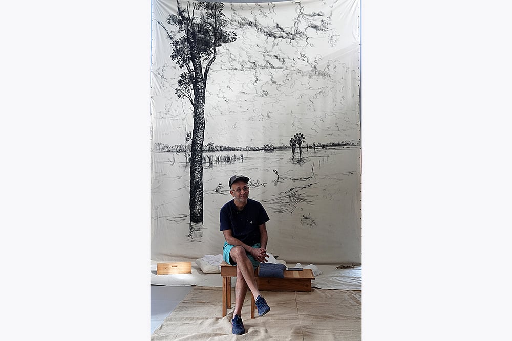 Bengal Biennale Nikhil Chopra infront of his artwork 