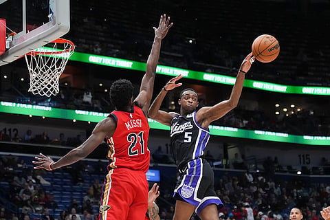 NBA: Kings guard De'Aaron Fox (5) passes the ball away from Pelicans center Yves Missi
