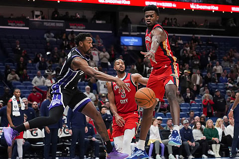 NBA: Kings guard Malik Monk passes around Pelicans center Yves Missi