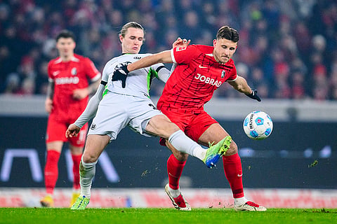 Bundesliga 2024-25: Wolfsburg's Patrick Wimmer and Freiburg's Maximilian Eggestein in action 
