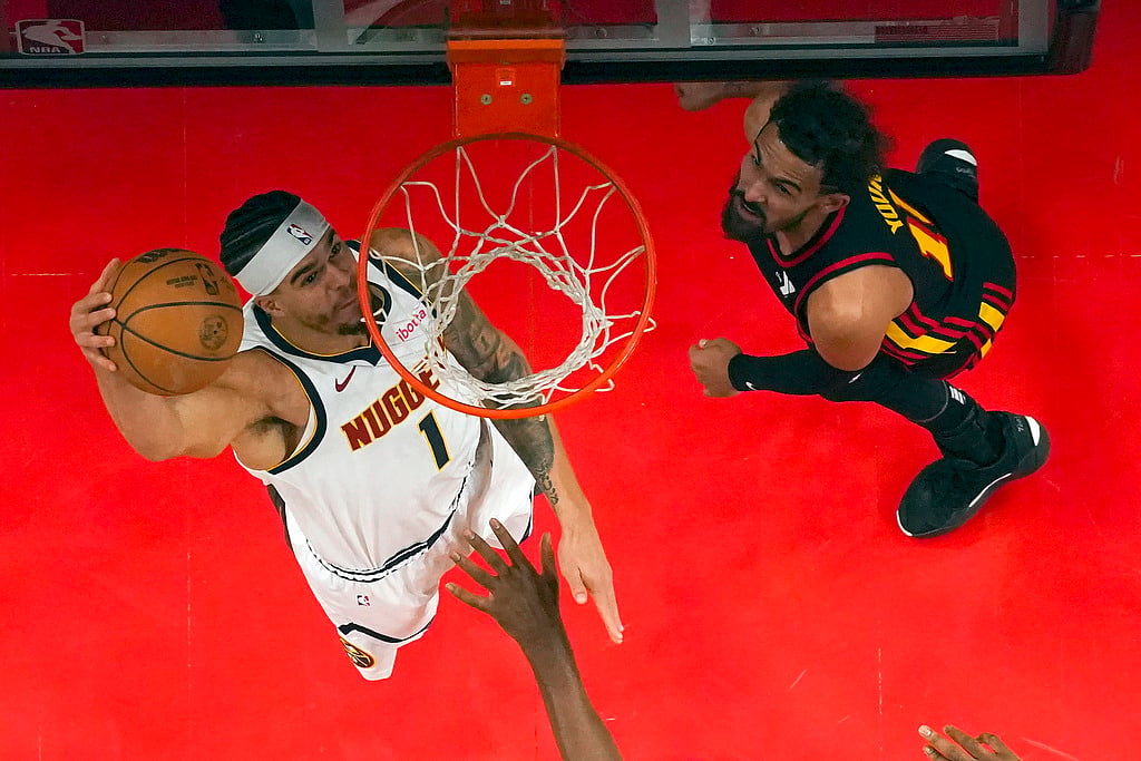 AP Photo/John Bazemore : Denver Nuggets forward Michael Porter Jr. (1) takes a shot as Atlanta Hawks guard Trae Young (11) defends in the first half of an NBA basketball game, Sunday, Dec. 8, 2024, in Atlanta.
