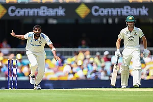 | Photo: AP/Pat Hoelscher : India Vs Australia, 3rd Test Day 2: India's Jasprit Bumrah, left, reacts as he bowls