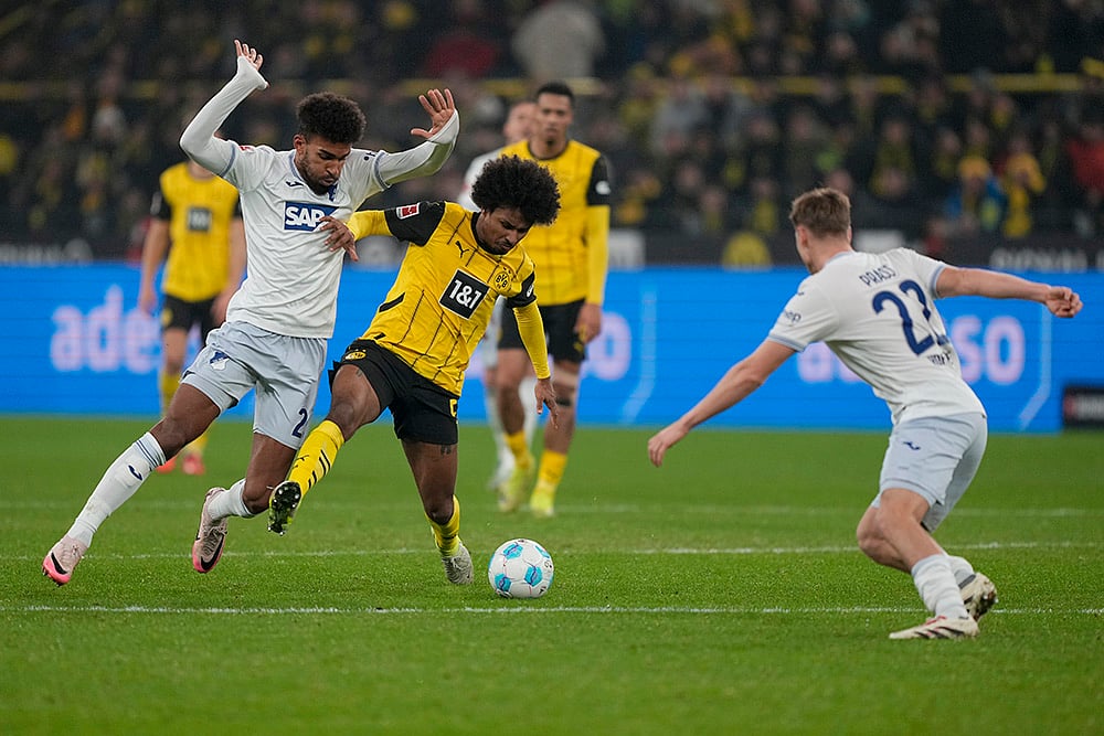| Photo: AP/Martin Meissner : Bundesliga 2024-25: Dortmund's Karim, Adeyemi Hoffenheim's, center, and Kevin Akpoguma, left, vie for the ball