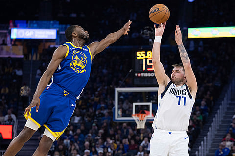 NBA 2024-25: Warriors forward Andrew Wiggins defends against Mavericks forward Luka Dončić