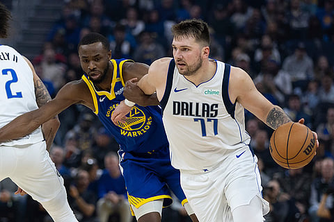 NBA 2024-25: Warriors forward Andrew Wiggins  defends against Mavericks forward Luka Dončić