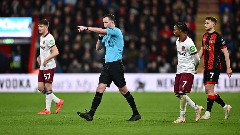 Referee Chris Kavanagh awards a penalty to West Ham. - null