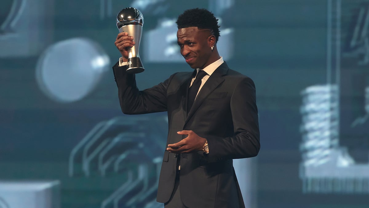 Vinicius Junior holds his FIFA Men's Best Player award aloft