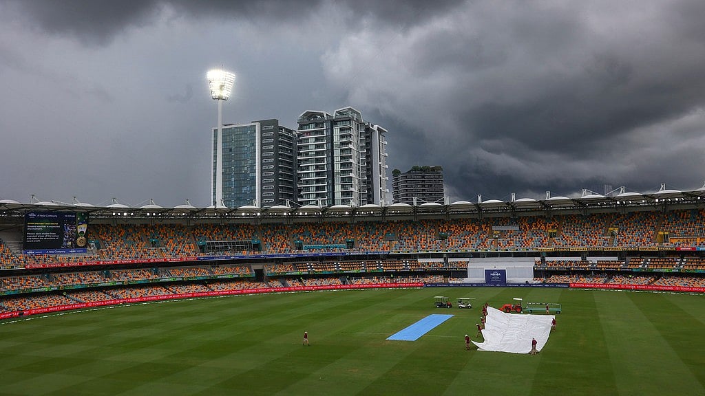 Ground staff place covers over the pitch as rain suspends play on day five of the third cricket test between India and Australia at the Gabba in Brisbane, Australia, Wednesday, Dec. 18, 2024. - AP Photo/Pat Hoelscher