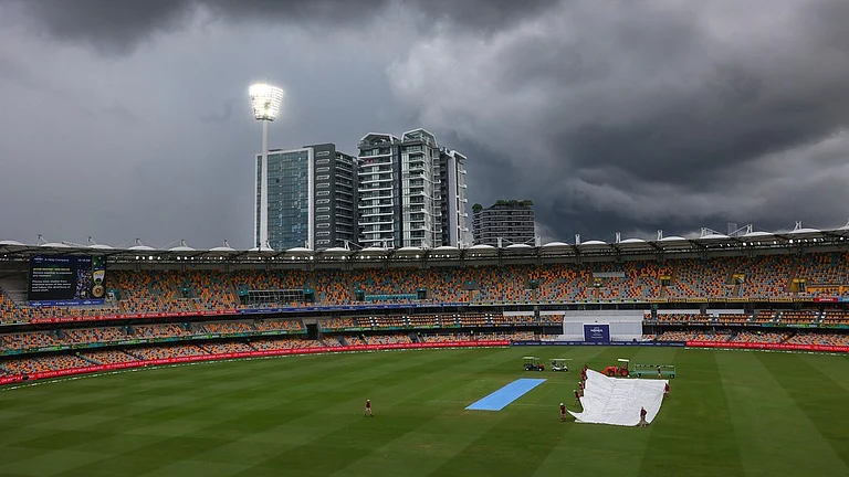 Ground staff place covers over the pitch as rain suspends play on day five of the third cricket test between India and Australia at the Gabba in Brisbane, Australia, Wednesday, Dec. 18, 2024. - AP Photo/Pat Hoelscher
