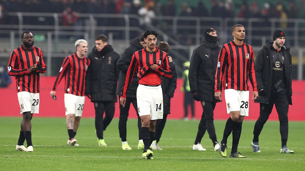 Milan's players trudge off after their draw with Genoa