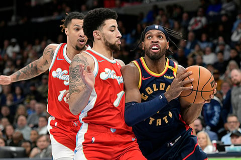 NBA: Warriors guard Buddy Hield, right, handles the ball against Grizzlies guard Scotty Pippen Jr.
