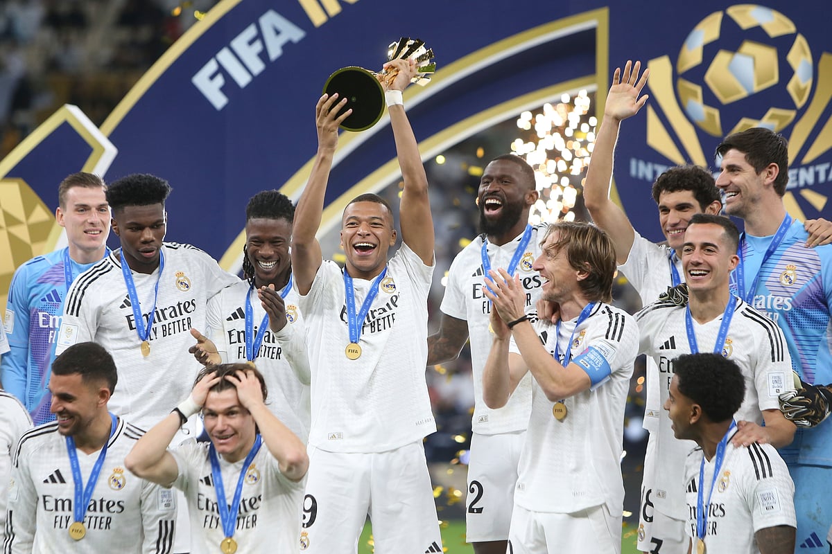 (AP Photo/Hussein Sayed) : Real Madrid's Kylian Mbappe, center, lifts the trophy after winning the Intercontinental Cup soccer final match against CF Pachuca at the Lusail Stadium in Lusail, Qatar, Wednesday, Dec. 18, 2024. Real Madrid won the game 3-0.