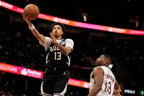 NBA 2024-25: Bucks guard Ryan Rollins (13) goes to the basket past Cavaliers center Tristan Thompson