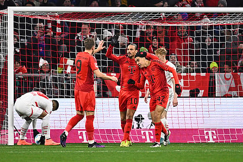 Bundesliga 2024-25: Munich's Jamal Musiala, right, celebrates scoring