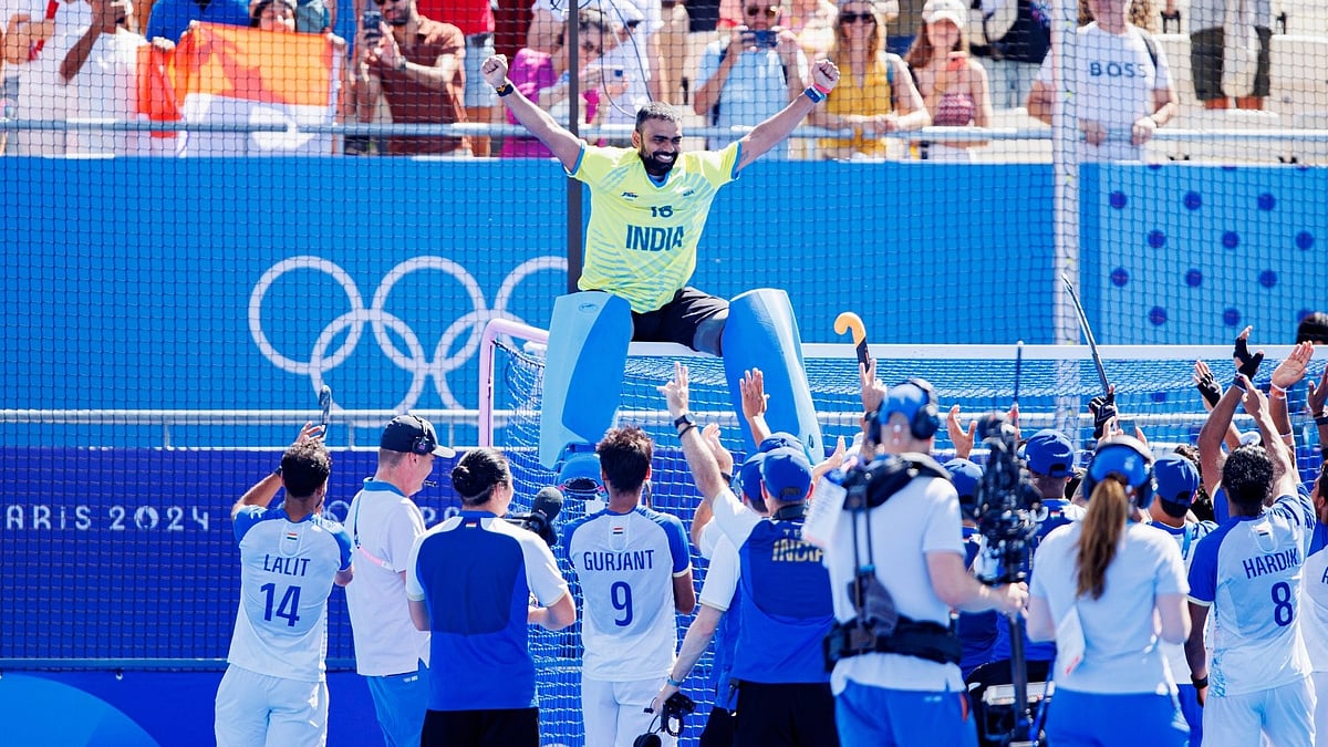 Photo: X | Hockey India : PR Sreejesh climbs up the goalpost after India secure the bronze medal in the Paris Olympics 2024.