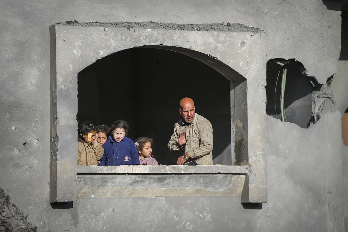 AP : Neighbours watch funeral procession of victims of an Israeli airstrike on Dec 22 2024 |