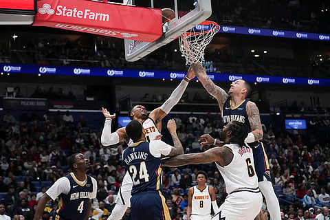 NBA 2024-25: Pelicans center Daniel Theis, right, leaps for a rebound 
