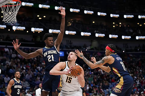 NBA 2024-25: Nuggets center Nikola Jokic (15) goes to the basket against Pelicans 