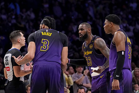 NBA 2024-25: Lakers forwards Anthony Davis (3), LeBron James (23) and Rui Hachimura (28) argue a call with a referee