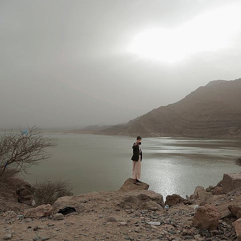 In this July 30, 2018 photo, a boy takes a 'selfie' with the Marib Dam in Yemen |