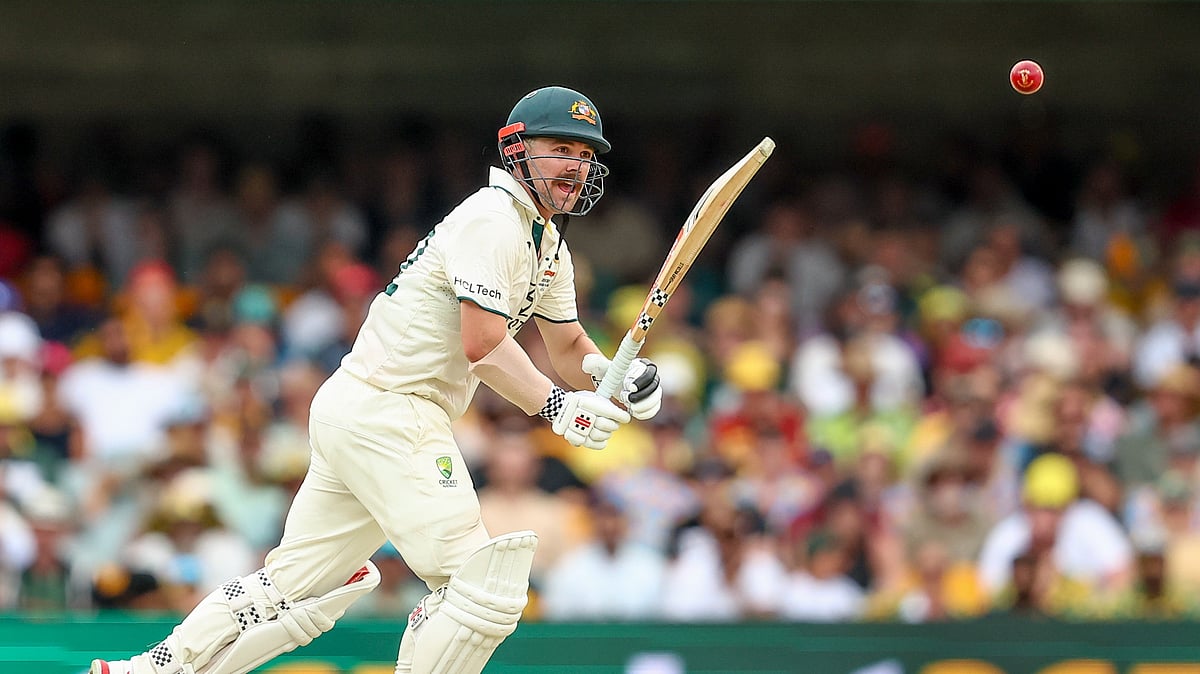 AP Photo/Pat Hoelscher : Australia's Travis Head watches the ball after playing a shot during play on day two of the third cricket test between India and Australia at the Gabba in Brisbane.