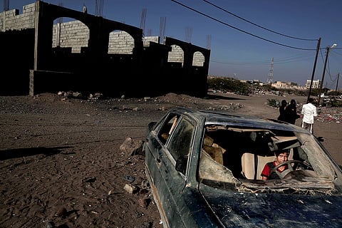 A boy sits in a car damaged during the ongoing three year conflict in Mocha, Yemen, Feb. 10, 2018 |