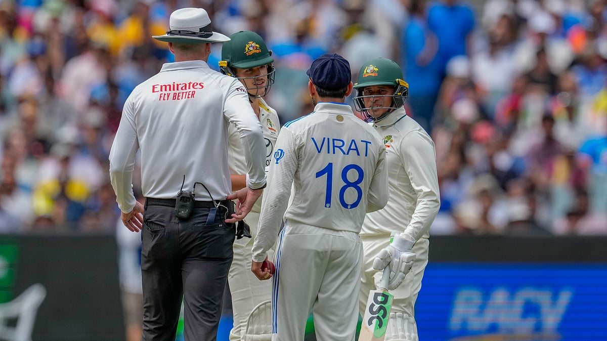 AP Photo/Asanka Brendon Ratnayake : India's Virat Kohli, talks to Australia's Sam Konstas, second left, as Australia's Usman Khawaja, right, looks on during play on the first day of the fourth cricket test between Australia and India at the Melbourne Cricket Ground, Melbourne.