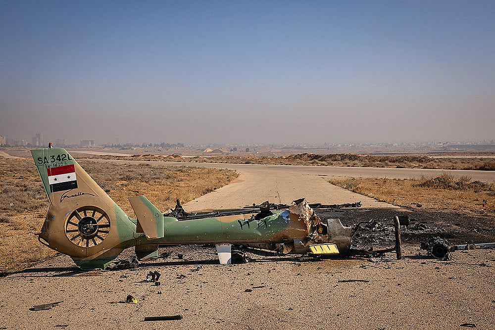 A Syrian Air Force helicopter is destroyed after Israeli 
strikes