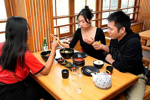 A group of friends enjoys authentic Korean cuisine at Gangnam Korean Restaurant in Majnu-ka-Tilla.