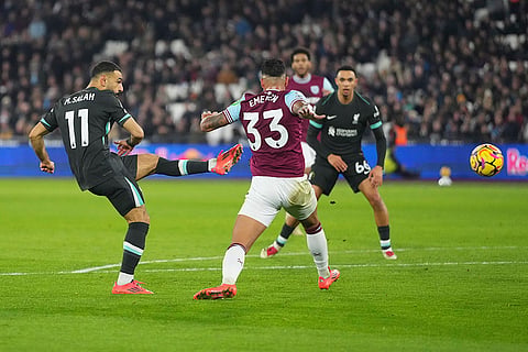 EPL 2024-25: Liverpool's Mohamed Salah, left, shoots in an attempt to score
