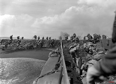 In the Pacific theater of World War II, U.S. Marines hit the beach and charge over a dune on Iwo Jima in the Volcano Islands Feb. 19, 1945, the start of one of the deadliest battles of the war against Japan |