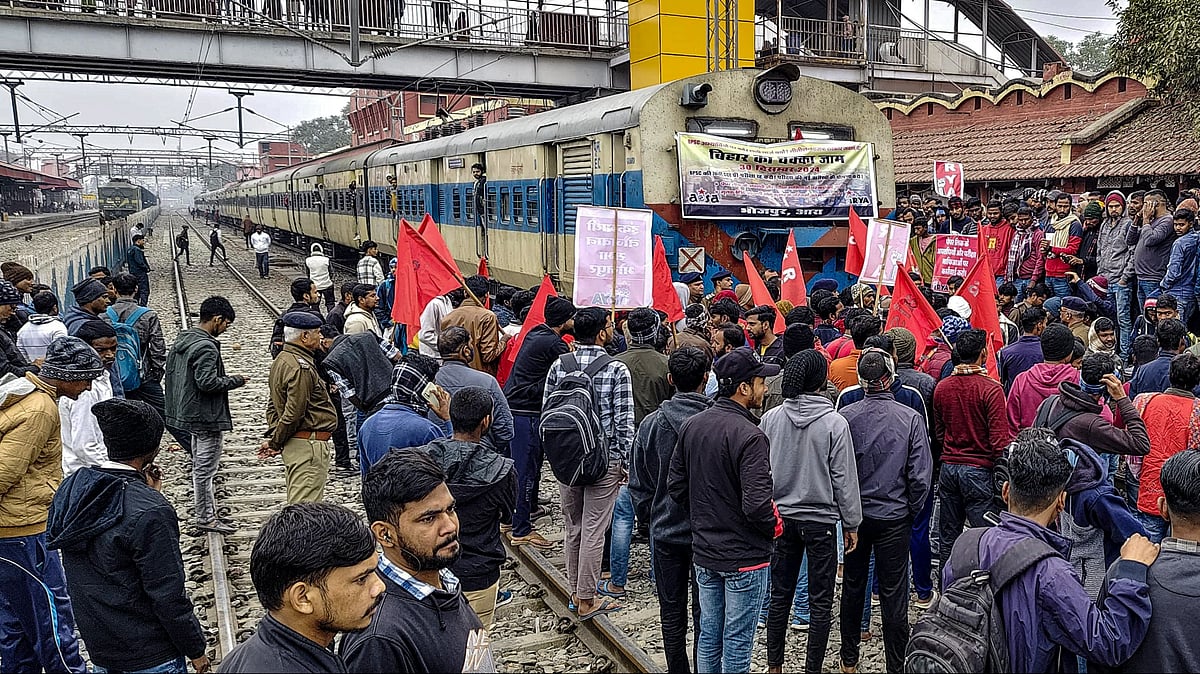 PTI :  AISA activists stop a train during 'Chakka Jam' protest over BPSC 70th exam, in Arrah, Bihar, Monday, Dec. 30, 2024.