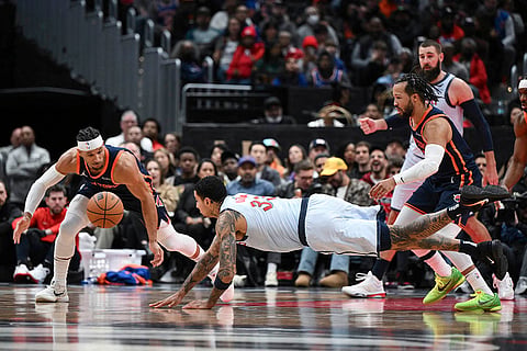 NBA 2024-25: Wizards forward Kyle Kuzma (33) loses possession and dives for the ball