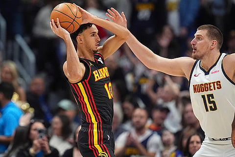 NBA 2024-25: Hawks forward Zaccharie Risacher, left, looks to pass the ball