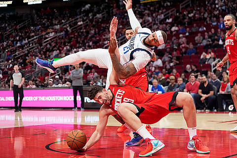 NBA 2024-25: Rockets' Alperen Sengun, bottom, is fouled by Mavericks' Daniel Gafford