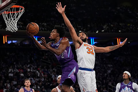 NBA 2024-25: Jazz's Collin Sexton (2) drives past Knicks' Karl-Anthony Towns